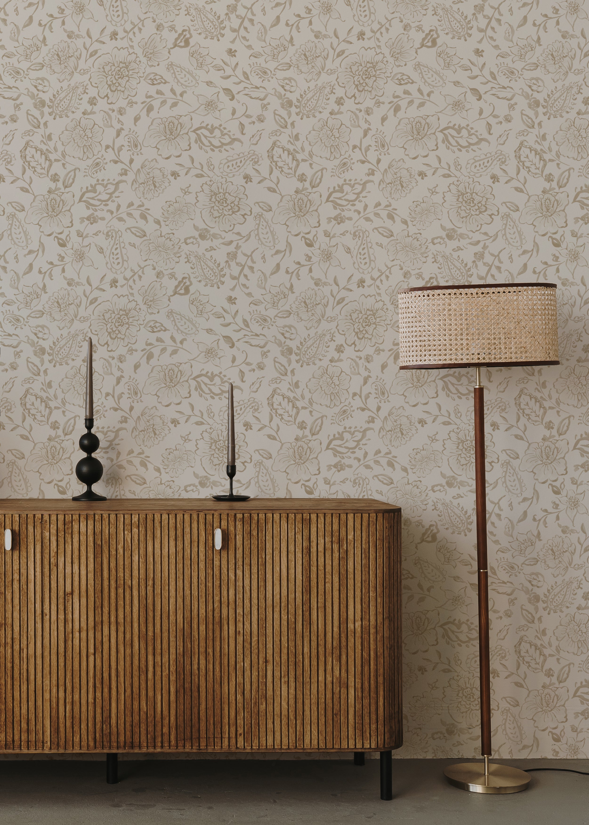 Close-up of Watercolour Paisley Wallpaper pattern with modern lamp and decor items on a wooden desk