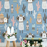 Children's room decorated with llama-themed wallpaper featuring playful llamas and cacti on a blue background.