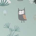 A detailed section of the 'Forest Critters Kids Wallpaper' showing an adorable owl perched among an assortment of forest plants, depicted in a gentle, hand-drawn style on a muted teal background.