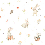 A charming pattern featuring watercolor bunnies in various activities, such as reading and playing, along with birds, flowers, and leaves, all set against a white background with colorful dots. The design evokes a sense of a peaceful, natural world filled with wonder.