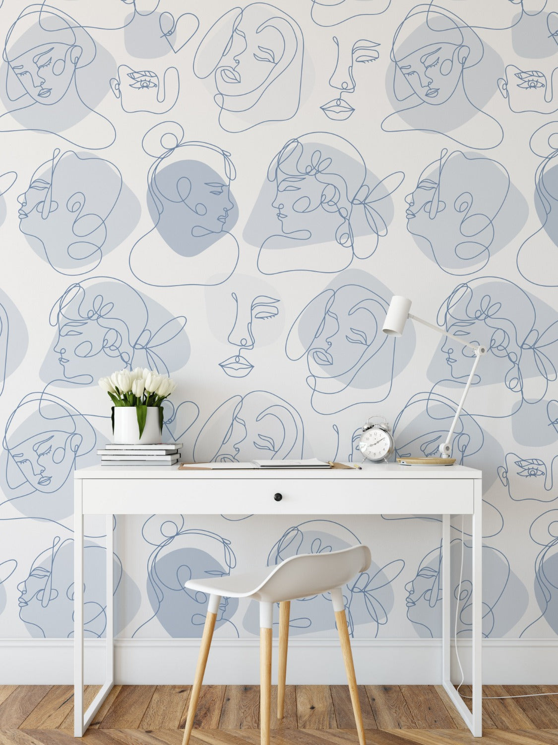 Another room setup featuring the abstract line art faces wallpaper. The design adds an artistic touch to a simple office space with a white desk, a modern chair, and minimal decorations, highlighting how the wallpaper can transform a working environment.