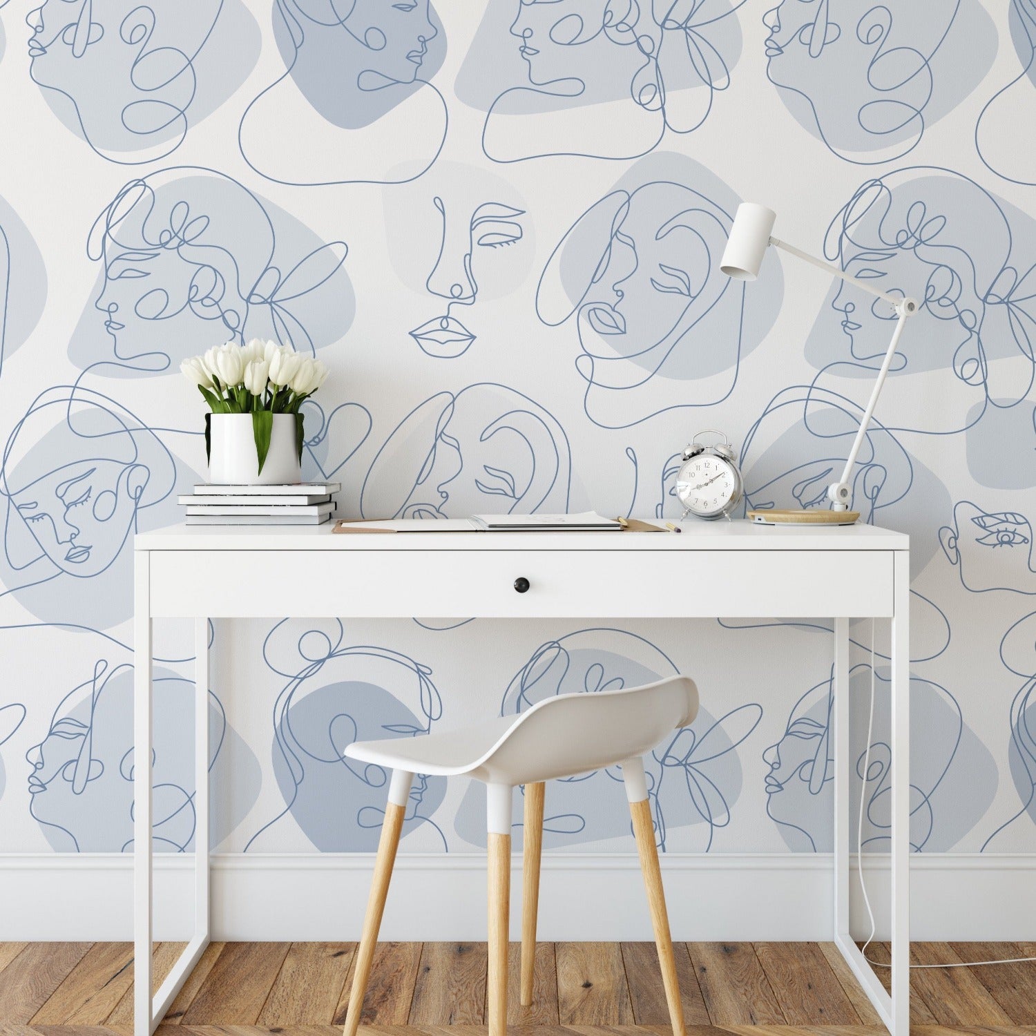 Another room setup featuring the abstract line art faces wallpaper. The design adds an artistic touch to a simple office space with a white desk, a modern chair, and minimal decorations, highlighting how the wallpaper can transform a working environment.