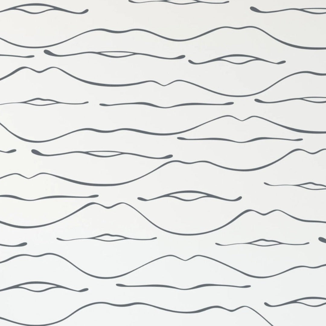 Close-up of a minimalistic wallpaper design with black abstract line drawings resembling gentle waves or minimalist facial features, set against a clean white background. The pattern is simple and repetitive, creating a calming and artistic backdrop.