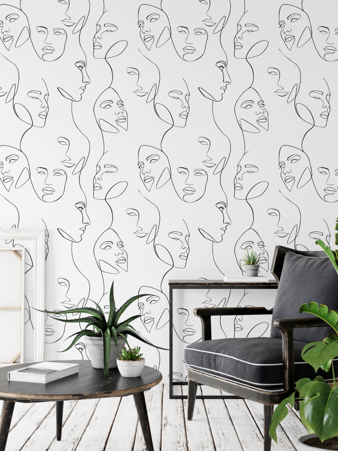 A contemporary room with a wall adorned by the Abstract and Minimal Wallpaper - Line Art III, which displays an array of interconnected black line art faces, offering a bold yet simplistic design element to the space.
