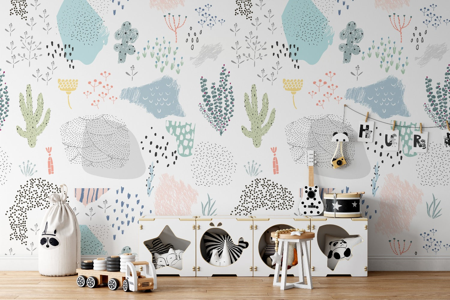 Children's room decorated with Kids Wallpaper - Doodles, showcasing playful doodles of plants, cacti, and abstract shapes in soft pastel colors on a white background.