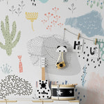Kids' play area featuring Kids Wallpaper - Doodles with whimsical doodles of various plants and abstract shapes in pastel colors, creating a fun and creative environment.