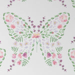 A close-up view of a wallpaper pattern with a creative design of butterflies formed by watercolor floral elements in gentle hues of pink, purple, and green, giving a delicate and enchanting appearance ideal for children's spaces