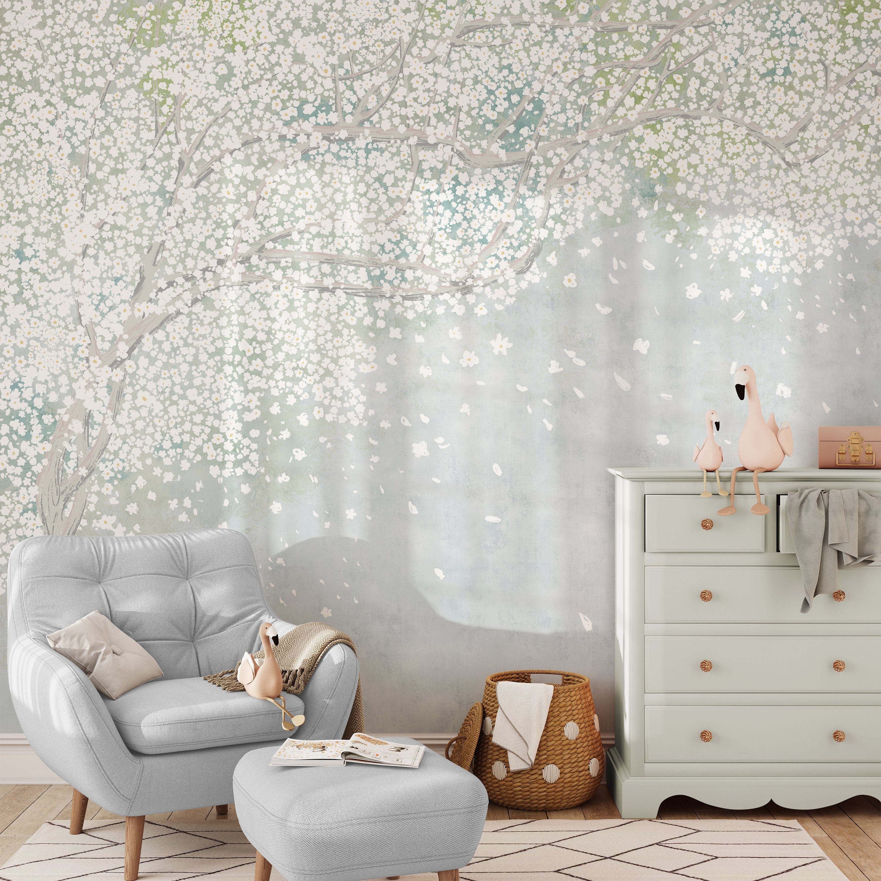 A comfortable reading nook graced by the Cherry Blossom Canopy wallpaper, its dreamy branches and flowers creating a tranquil backdrop. A plush grey armchair and matching footstool invite relaxation, with charming flamingo figurines on a white dresser completing the serene scene.