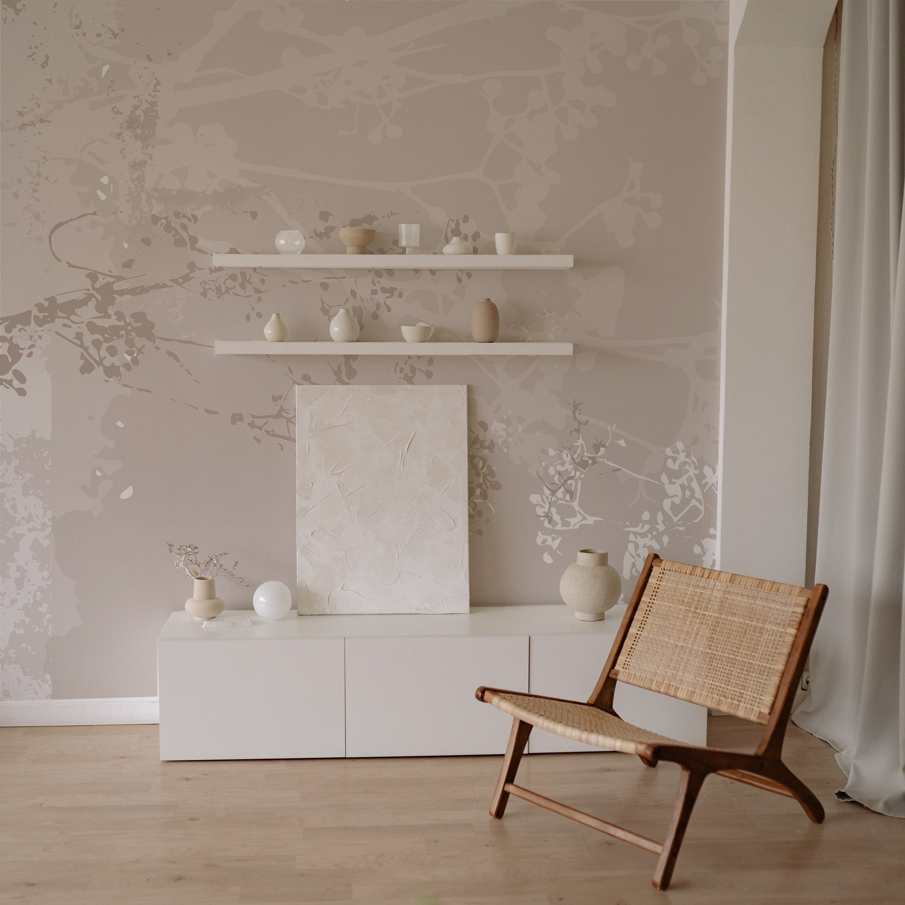 Modern Floral Mural Wallpaper with delicate floral branches in shades of beige, enhancing a living room with minimalist decor, including shelves and ceramic vases.