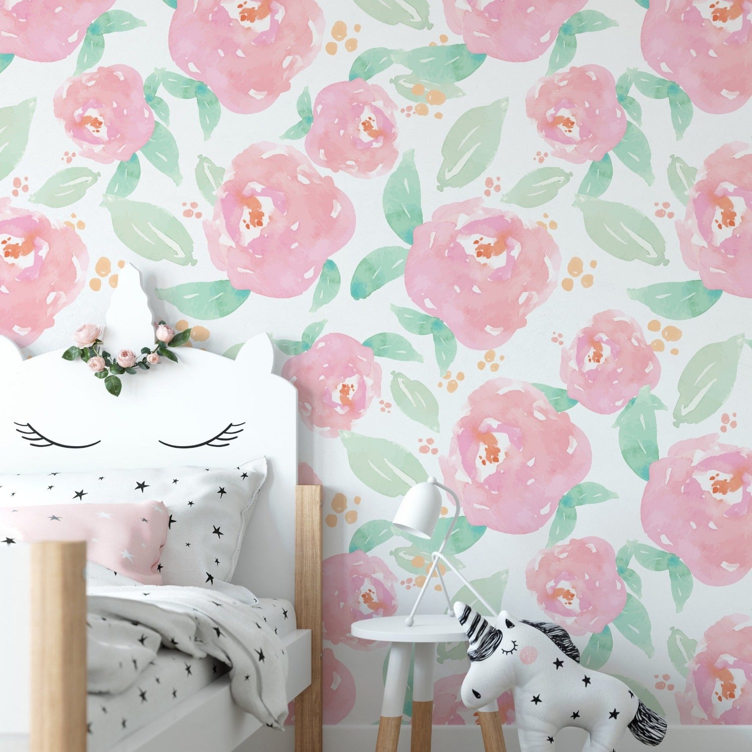 Child's nursery room showcasing walls covered with bright pink peony floral wallpaper and modern furniture
