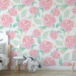 Nursery room decorated with bright nursery floral wallpaper featuring large pink peonies and green leaves