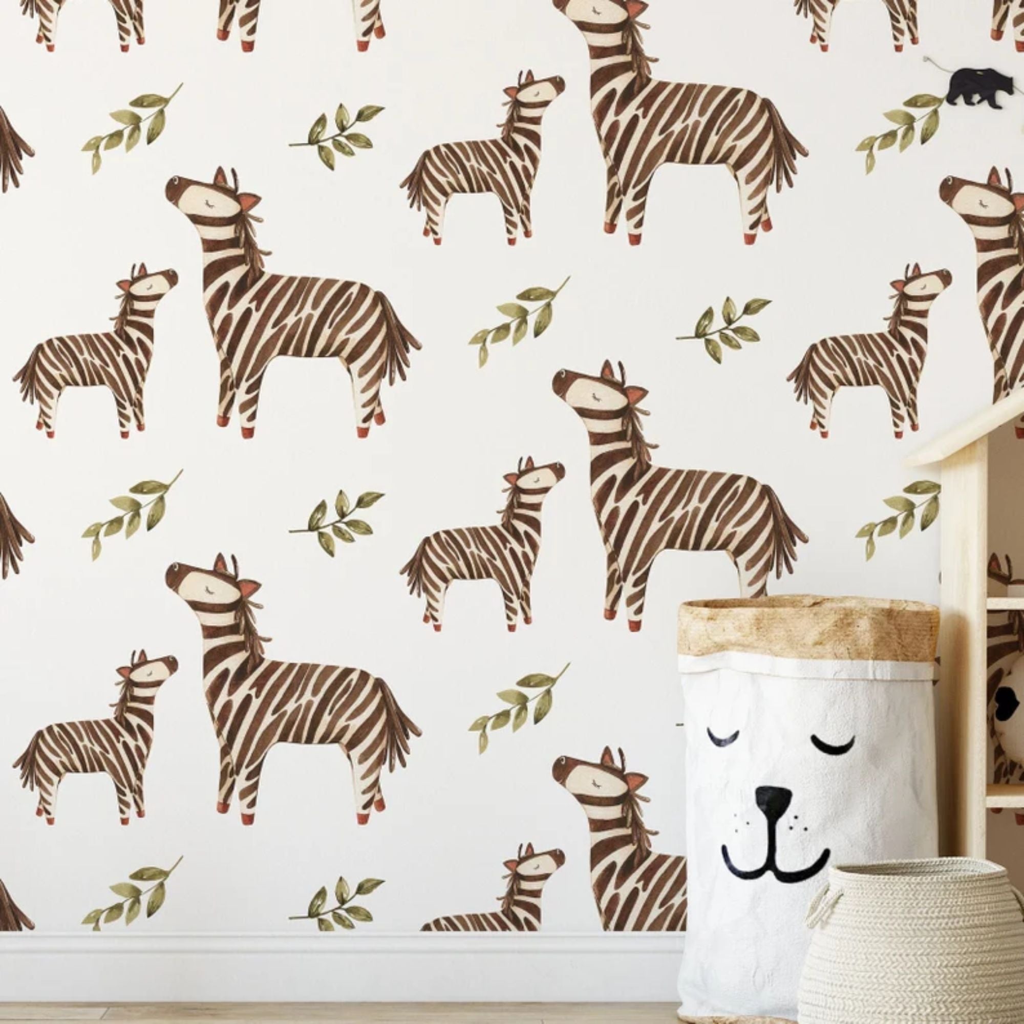 Wall covered with watercolor zebra wallpaper in a kid's room setting, showcasing matching decor