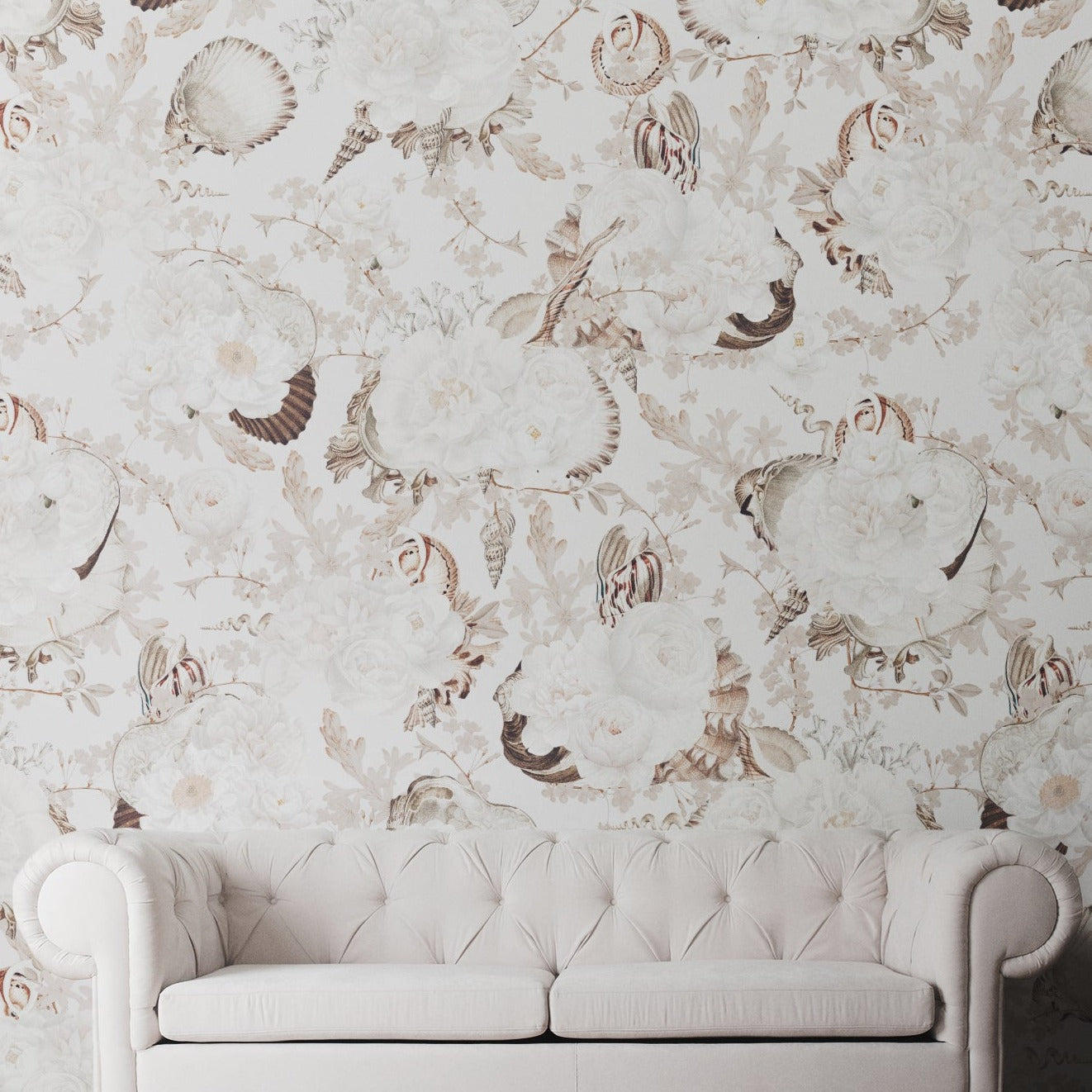 A stylish room with the Modern Aesthetic Wallpaper - Neutral on the wall. The room includes a white tufted sofa, complementing the elegant sea shell and floral wallpaper.