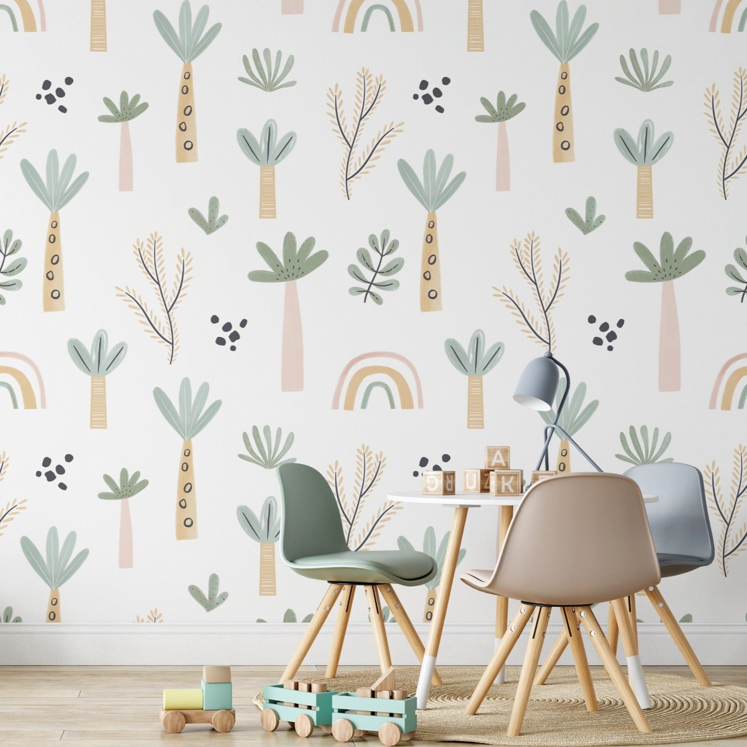 A cheerful children's room brightened by the Tropical Kids Room Wallpaper, depicting stylized trees and playful shapes. The room includes a small wooden desk with modern children's chairs in pastel colors, enhancing the playful atmosphere.