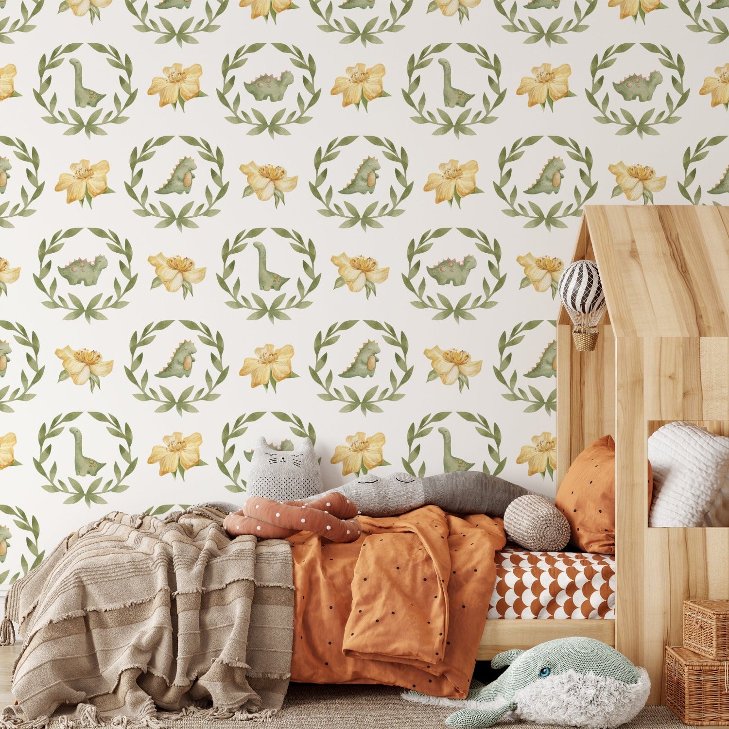 Nursery room decorated with baby dinosaur watercolor wallpaper featuring floral and dinosaur patterns.