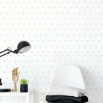 A modern workspace with the Gold Polka Dots Wallpaper creating an elegant backdrop for a white desk chair, black metal lamp, and artistic accessories, adding a playful yet chic atmosphere to the room