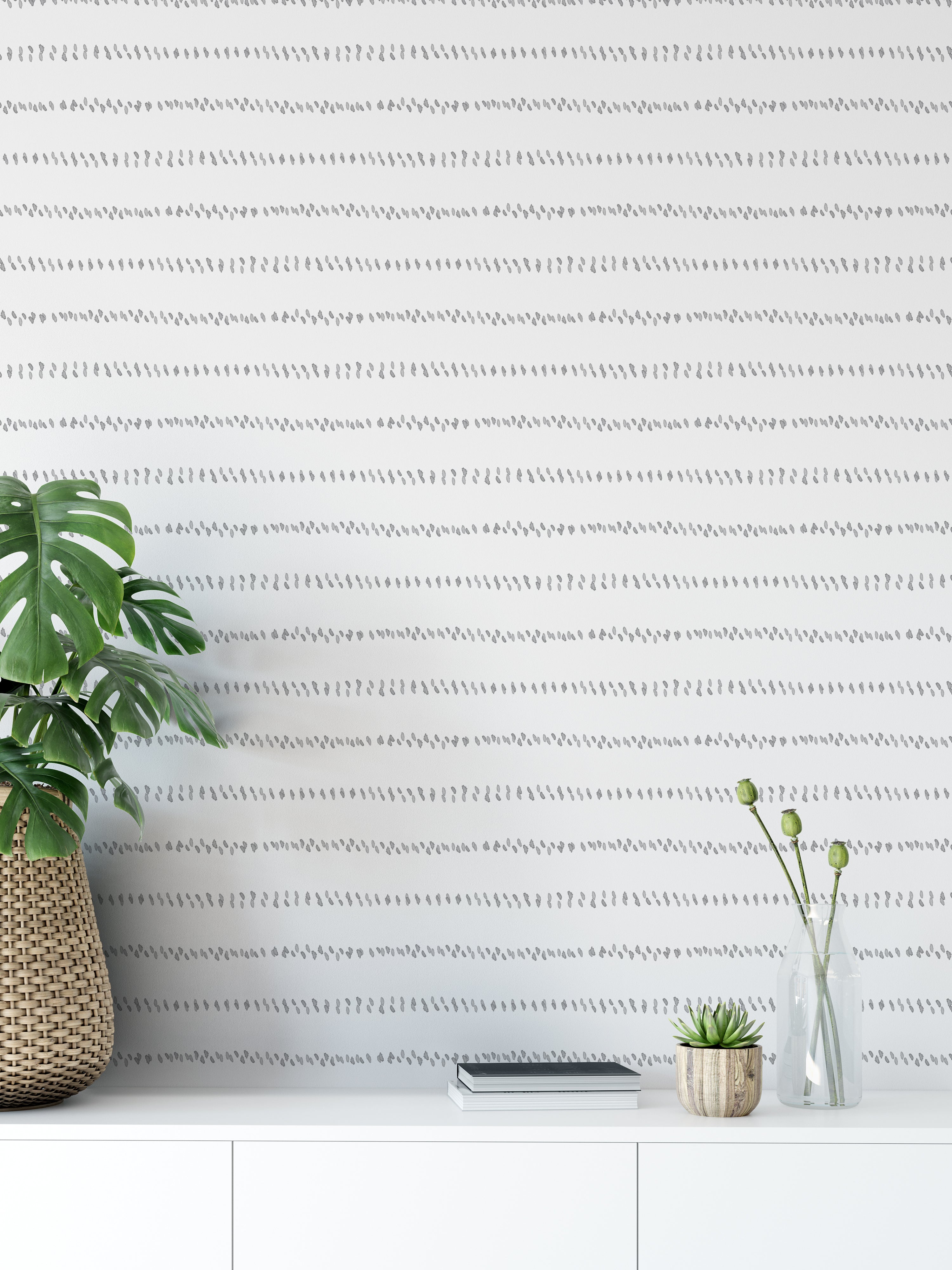 A modern room featuring the Watercolour Minimal Wallpaper II, with subtle gray watercolor dashes forming horizontal lines on a white wall, providing a serene and sophisticated backdrop that complements the contemporary decor.