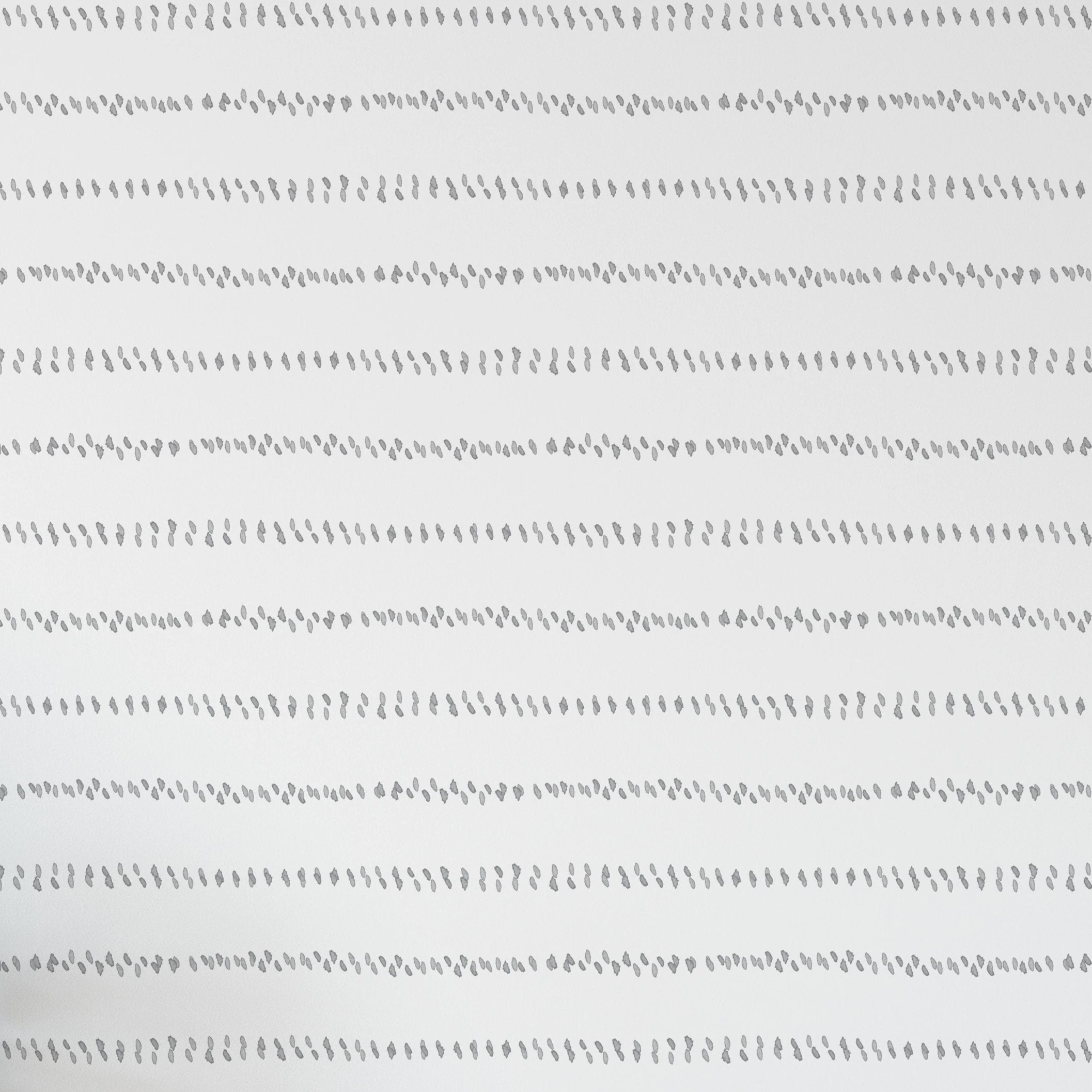 A seamless pattern of delicate, hand-painted watercolor dashes in grayscale, aligned in horizontal stripes across a white background. The brush strokes give a soft, organic feel to the minimalist design.