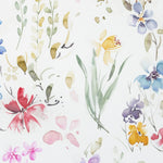 A detailed close-up of the Watercolour Floral Wallpaper XII showcasing a vibrant assortment of watercolor flowers in rich hues of red, yellow, blue, and pink, interspersed with delicate greenery on a white background, evoking a springtime garden in full bloom.