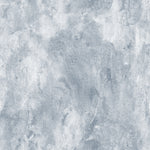 a close-up of the Blue Limewash Wallpaper, with a textured appearance that mimics the look of traditional limewash paint. The wallpaper features varying shades of soft blue with subtle hints of gray, creating a rustic and distressed finish. The effect is reminiscent of weathered walls in a Mediterranean villa, evoking a sense of history and casual elegance.