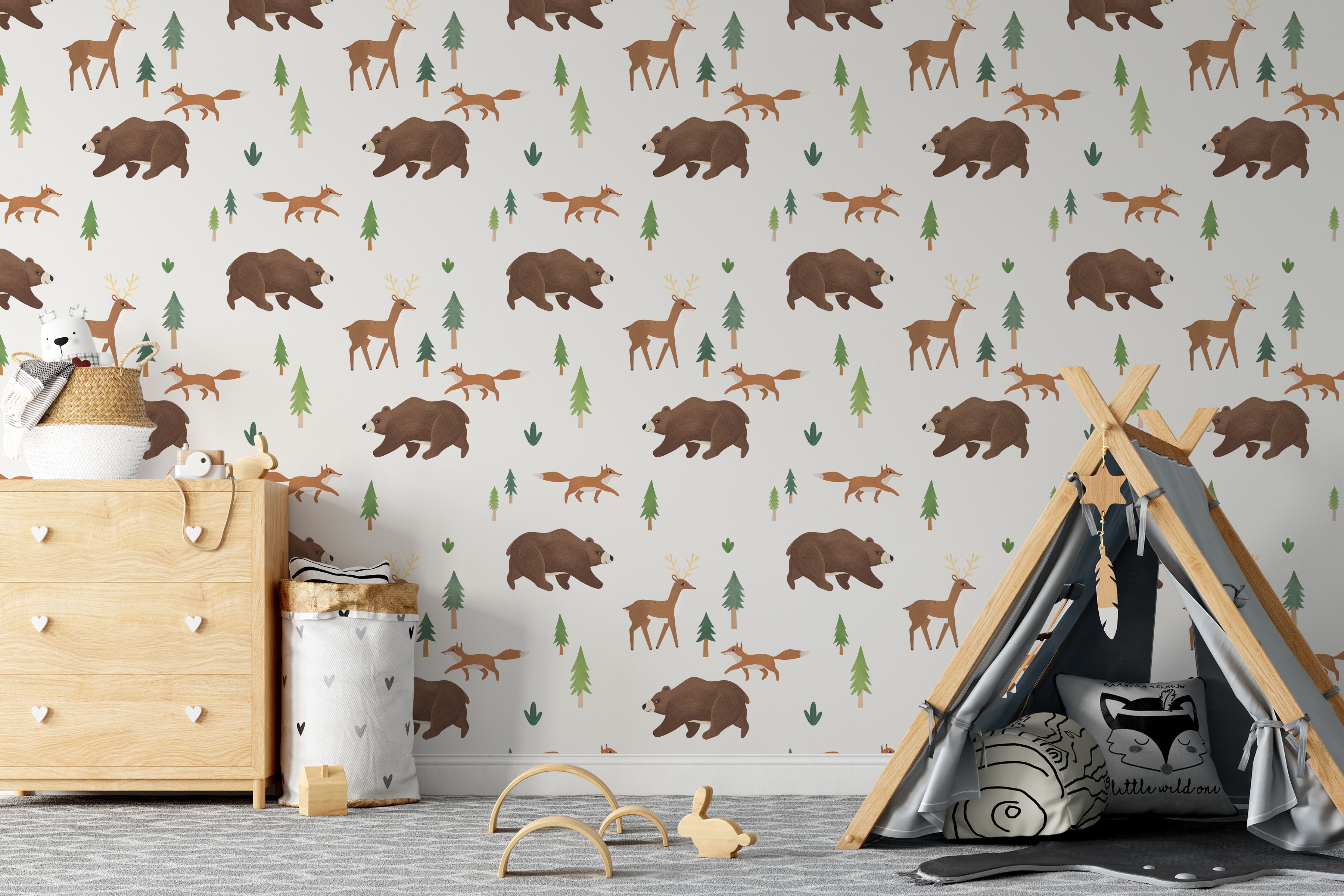 A child's room featuring a whimsical wallpaper with a repeating pattern of forest animals such as brown bears, deer, and foxes among green pine trees. The scene is complemented by a child's teepee, a wooden toy, and a light wood dresser, creating a playful and adventurous atmosphere.