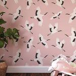 Elegant 'Kids Crane Wallpaper' in a children's playroom, featuring a pattern of white cranes in flight against a soft pink background, creating a serene and uplifting atmosphere