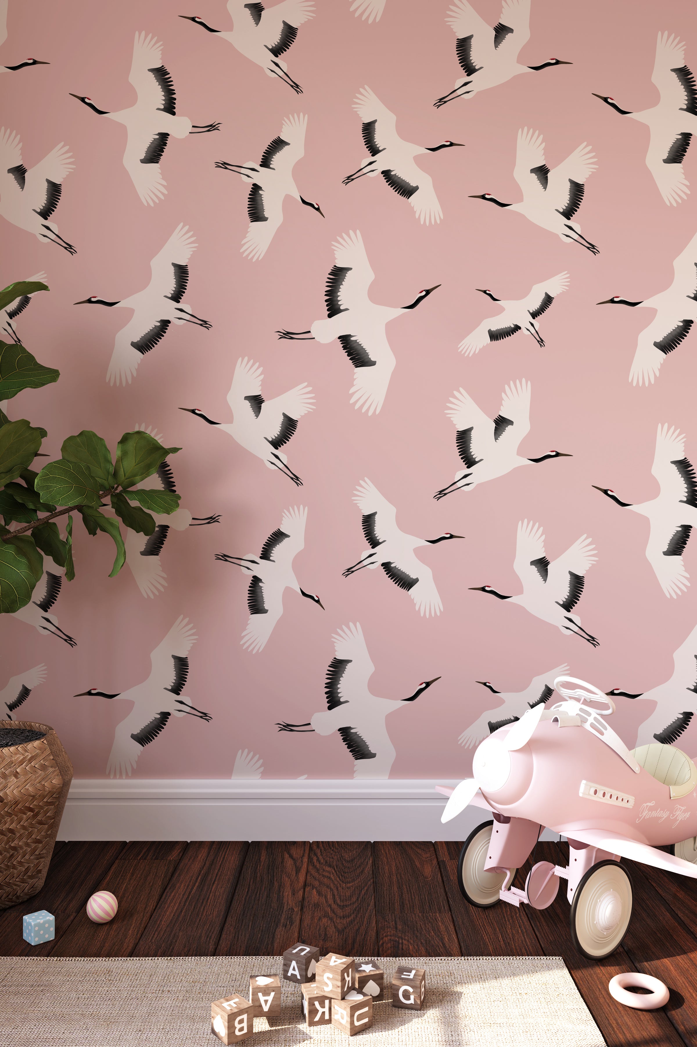 Elegant 'Kids Crane Wallpaper' in a children's playroom, featuring a pattern of white cranes in flight against a soft pink background, creating a serene and uplifting atmosphere