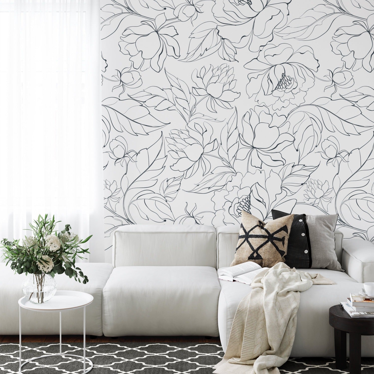 An unrolled roll of modern black floral wallpaper on a white background, presenting a monochrome floral design with prominent lines depicting a variety of flowers and leaves.
