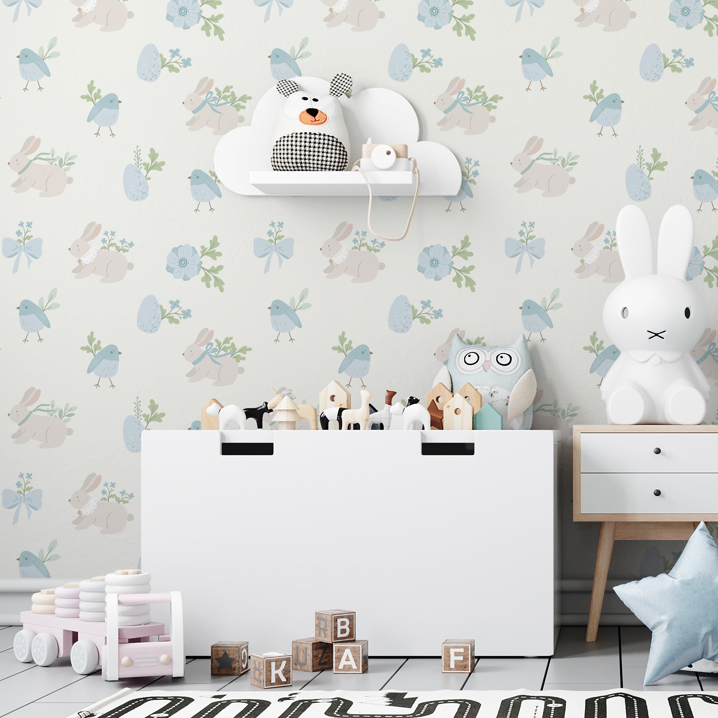Children’s room decorated with Bunny and Bird Wallpaper showing a playful and enchanting scene of pastel-colored bunnies and birds amidst floral accents and decorative eggs, enhancing the room's soft and inviting atmosphere.