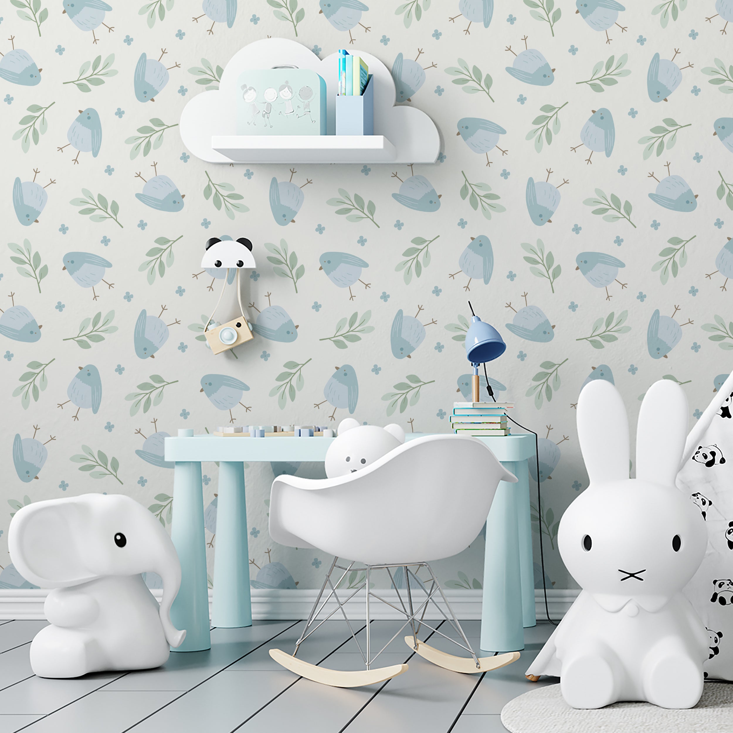 A delightful nursery room decorated with Baby Blue Bird Wallpaper, showcasing soft blue and green tones. The room features adorable children's furniture including a whimsical elephant chair and a panda lamp, creating a playful and soothing environment.