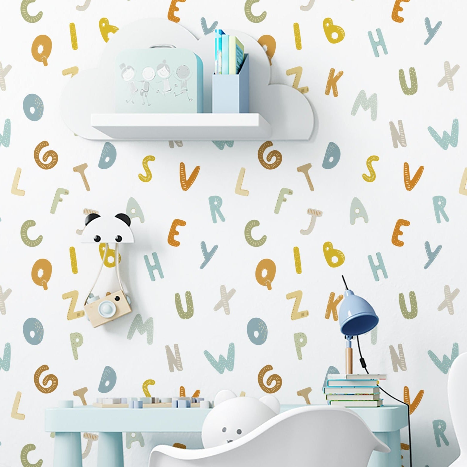 A child's nursery featuring 'Nursery Alphabet Wallpaper' with a playful array of multicolored letters in various fonts and patterns scattered across a white backdrop. A white elephant-shaped lamp and a whimsical bunny chair add to the room's fun, educational theme.