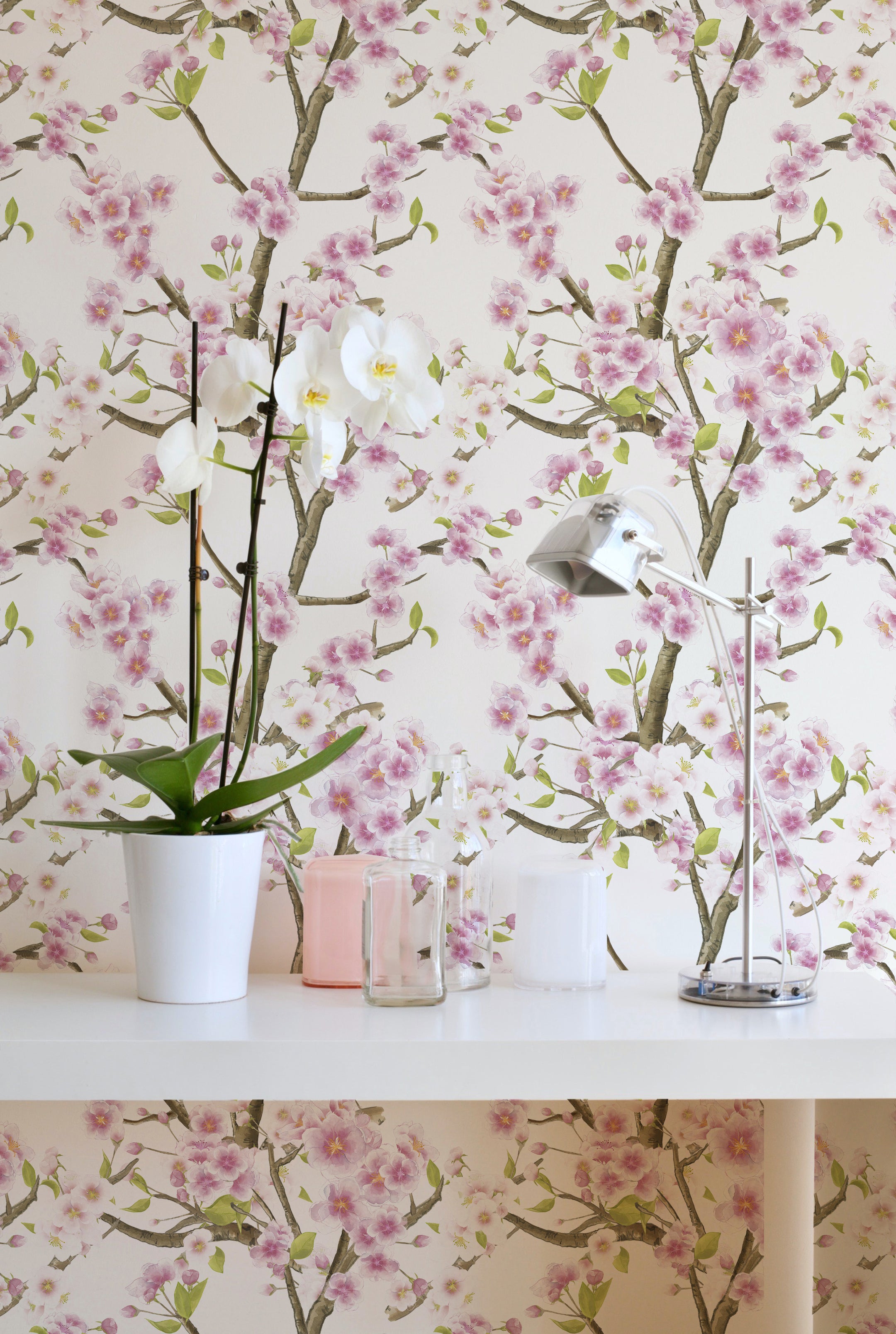 Sakura Blossom Wallpaper enhancing a contemporary bathroom setting, with vibrant pink cherry blossoms on slender branches spread across a white background, paired with modern decor and natural elements for a refreshing interior.
