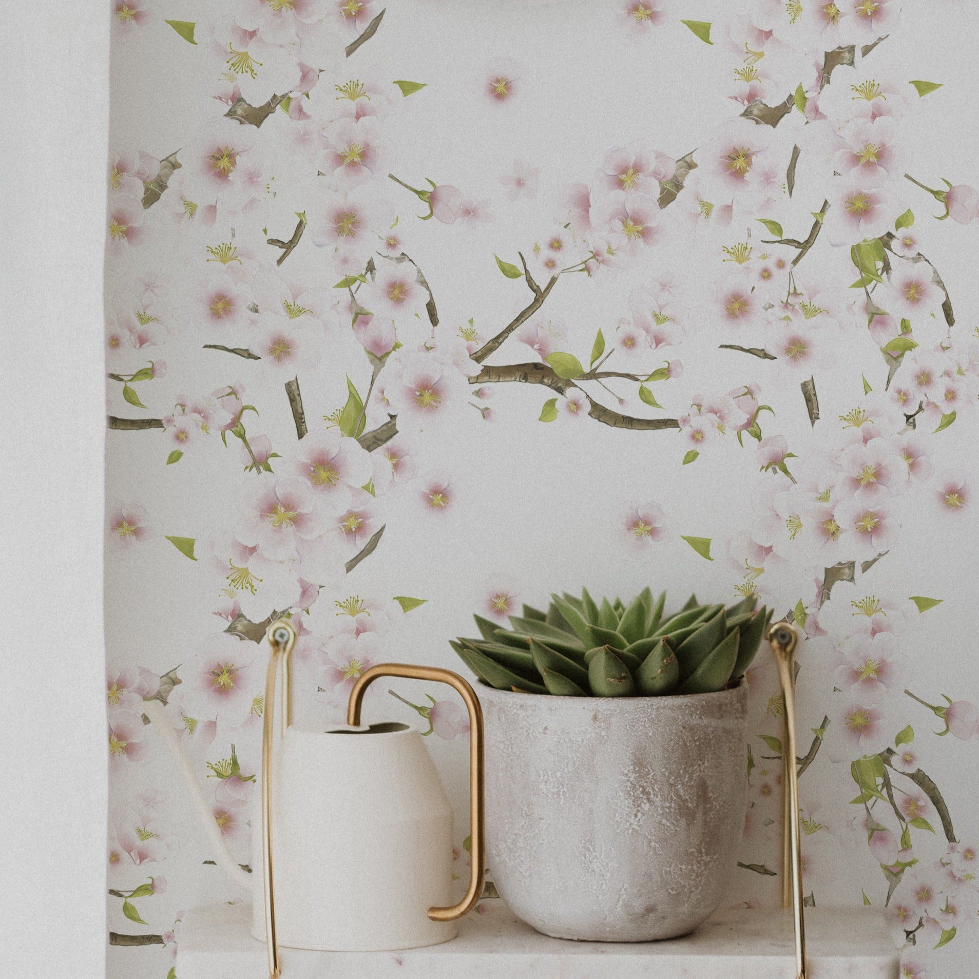 Room setting showcasing Sakura Wallpaper with pink cherry blossoms and green leaves, complemented by a white shelf with a potted plant and decorative items