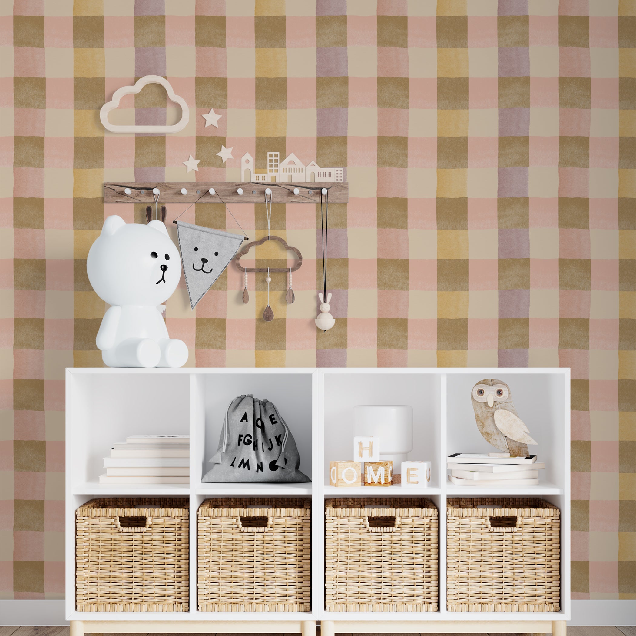 A nursery room wall adorned with Chloé Wallpaper, displaying a checkered pattern in pastel hues. The wall enhances the playful and calming environment, complemented by white shelves with children’s toys and decorative items