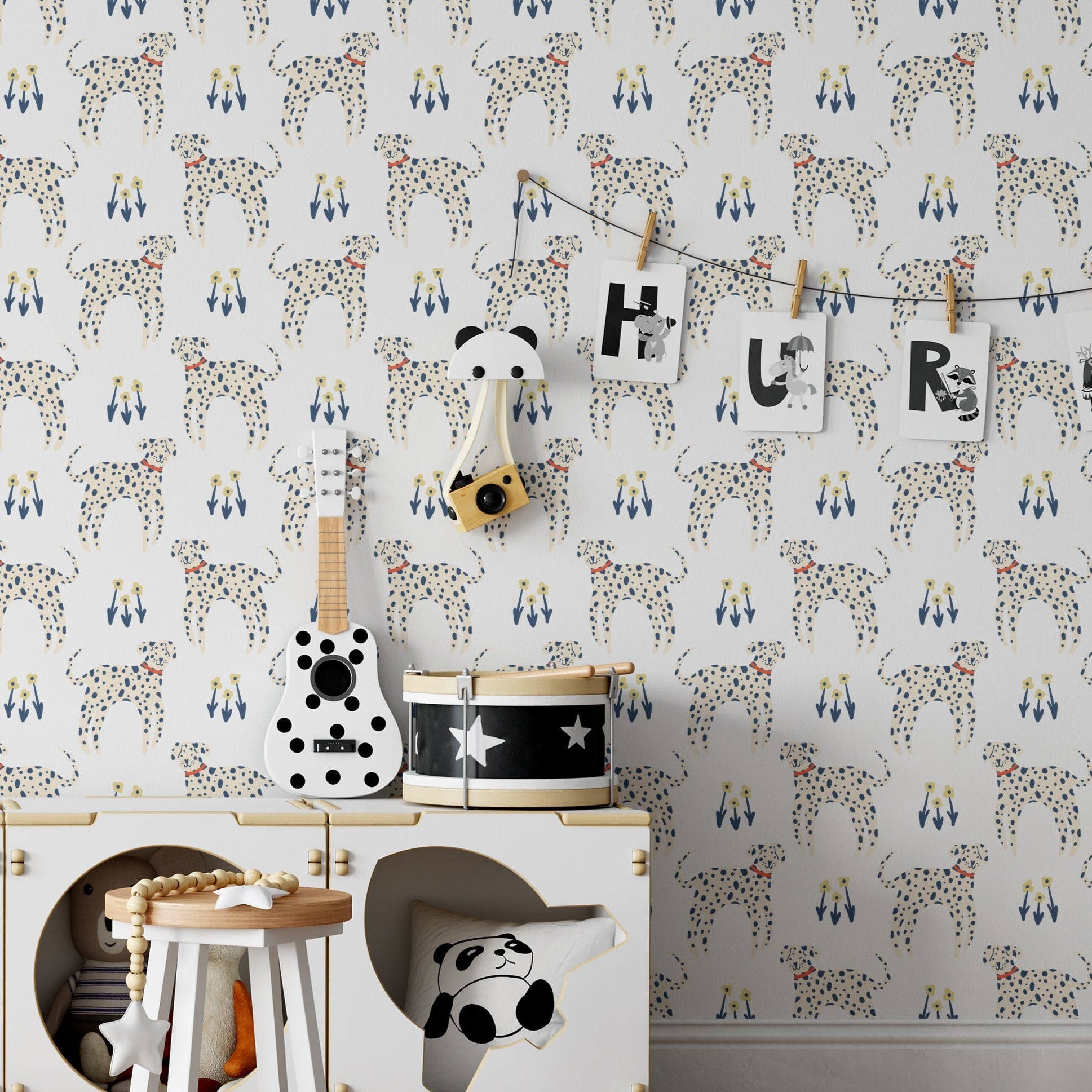 A child's nursery room adorned with 'Dog Wallpaper 33,' which displays playful Dalmatians and vibrant flowers in blue and yellow on a white background, creating a cheerful and inviting space