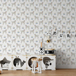 A child's nursery room adorned with 'Dog Wallpaper 33,' which displays playful Dalmatians and vibrant flowers in blue and yellow on a white background, creating a cheerful and inviting space