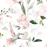 A close-up of the 'Watercolour Hummingbird Floral Wallpaper' reveals the artful detail of watercolor hummingbirds amidst blush-toned flowers and greenery, embodying the beauty of nature in a graceful design.