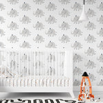 Elephant Party Wallpaper in a nursery setting, depicting charming gray elephants on a white background, complemented by a white crib and playful children's decor, creating a gentle and joyful atmosphere.