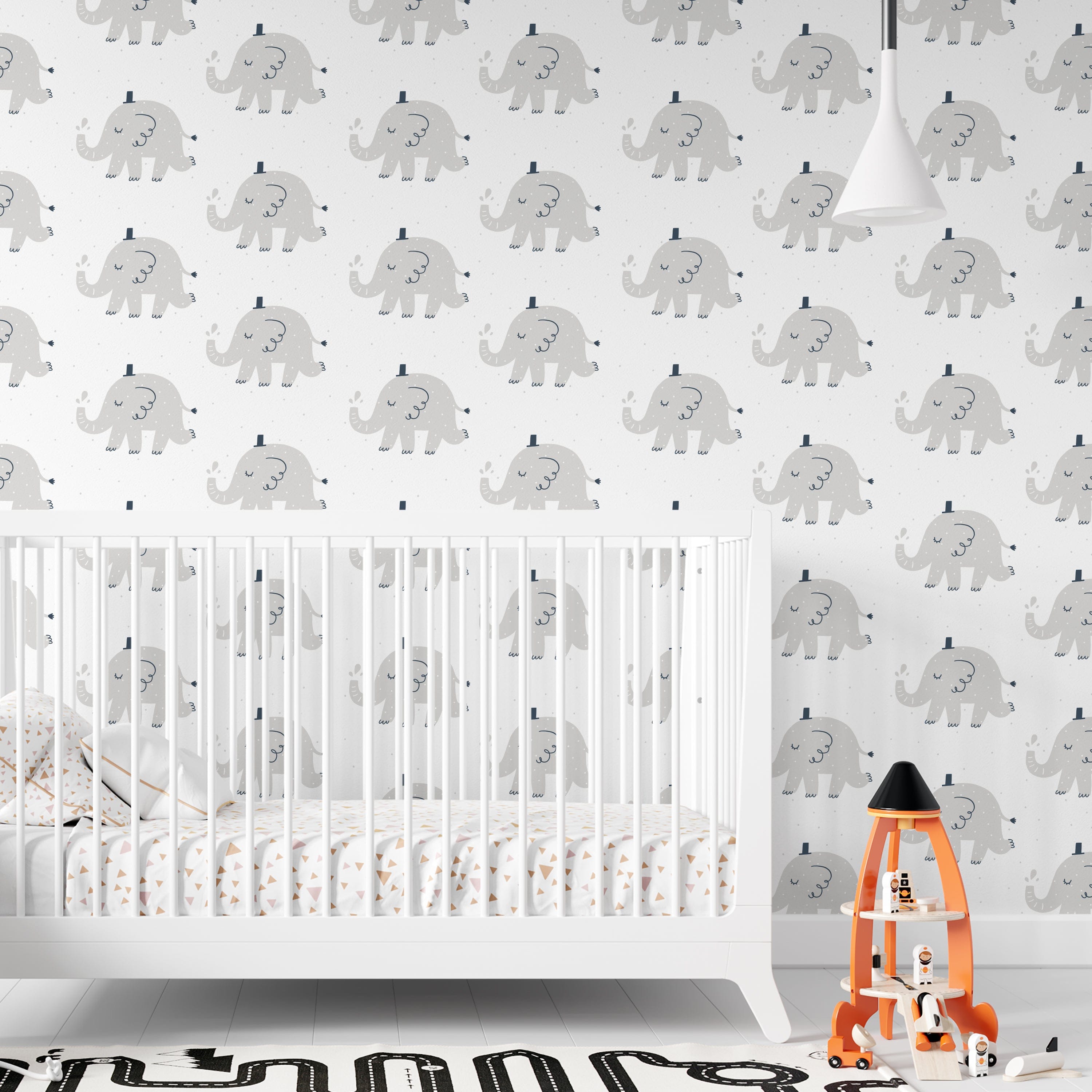 Elephant Party Wallpaper in a nursery setting, depicting charming gray elephants on a white background, complemented by a white crib and playful children's decor, creating a gentle and joyful atmosphere.