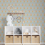 A cheerful and playful nursery room decorated with Baby Spring Wallpaper, featuring a pattern of soft pink flowers and delicate blue floral accents. The room includes children’s decor such as a whimsical cloud shelf and playful animal figurines, creating an enchanting and inviting space for little ones.