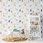 A child's room decorated with the Adventure Wallpaper, showcasing a lively and fun atmosphere. The wallpaper provides a backdrop to a simple wooden table and chairs, with a plush elephant toy on one chair, emphasizing the room's whimsical and youthful theme.
