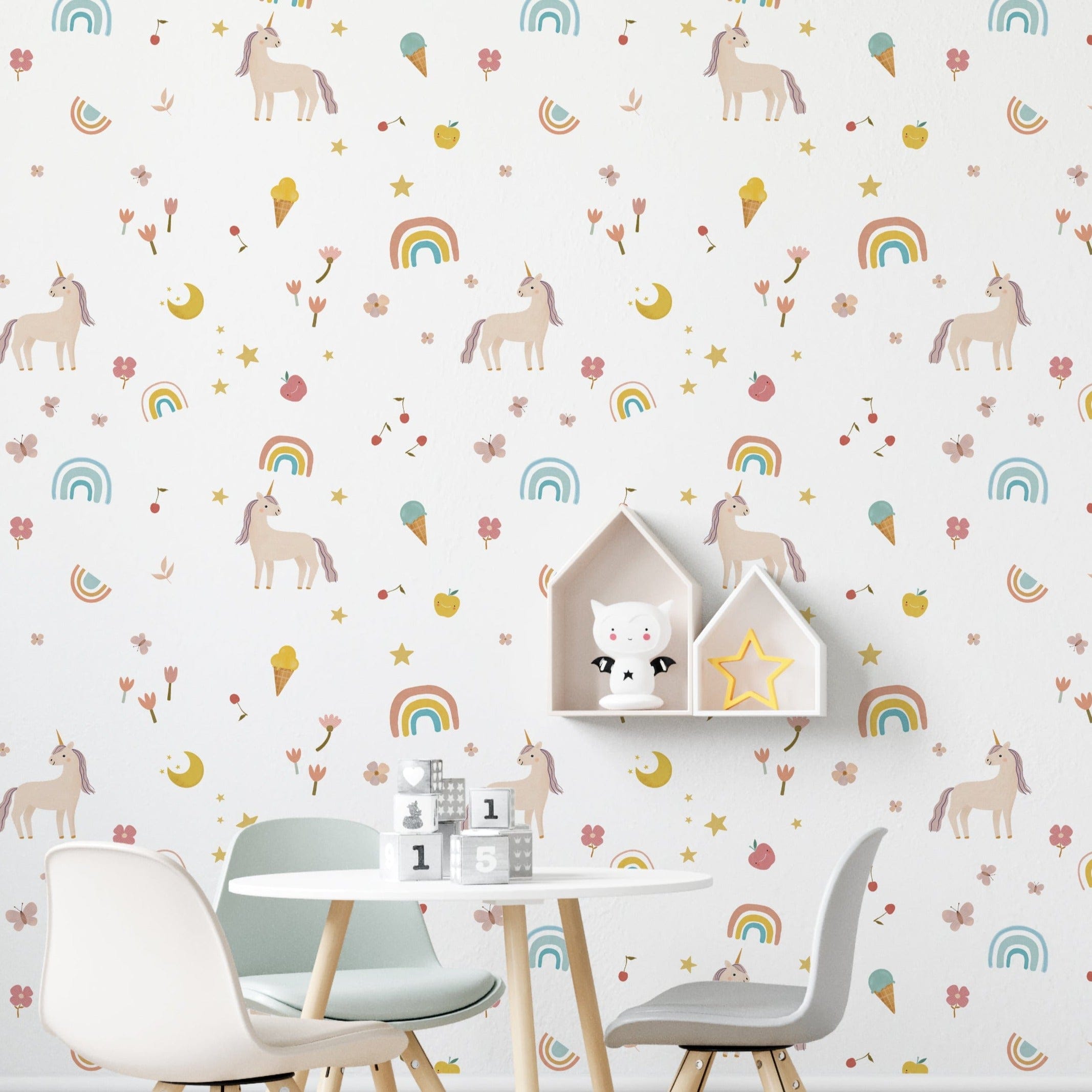 Children's play area with Unicorn Adventure Wallpaper, displaying a delightful pattern of pastel-colored unicorns, rainbows, and other whimsical elements, complemented by a white table and chairs with cute decor.
