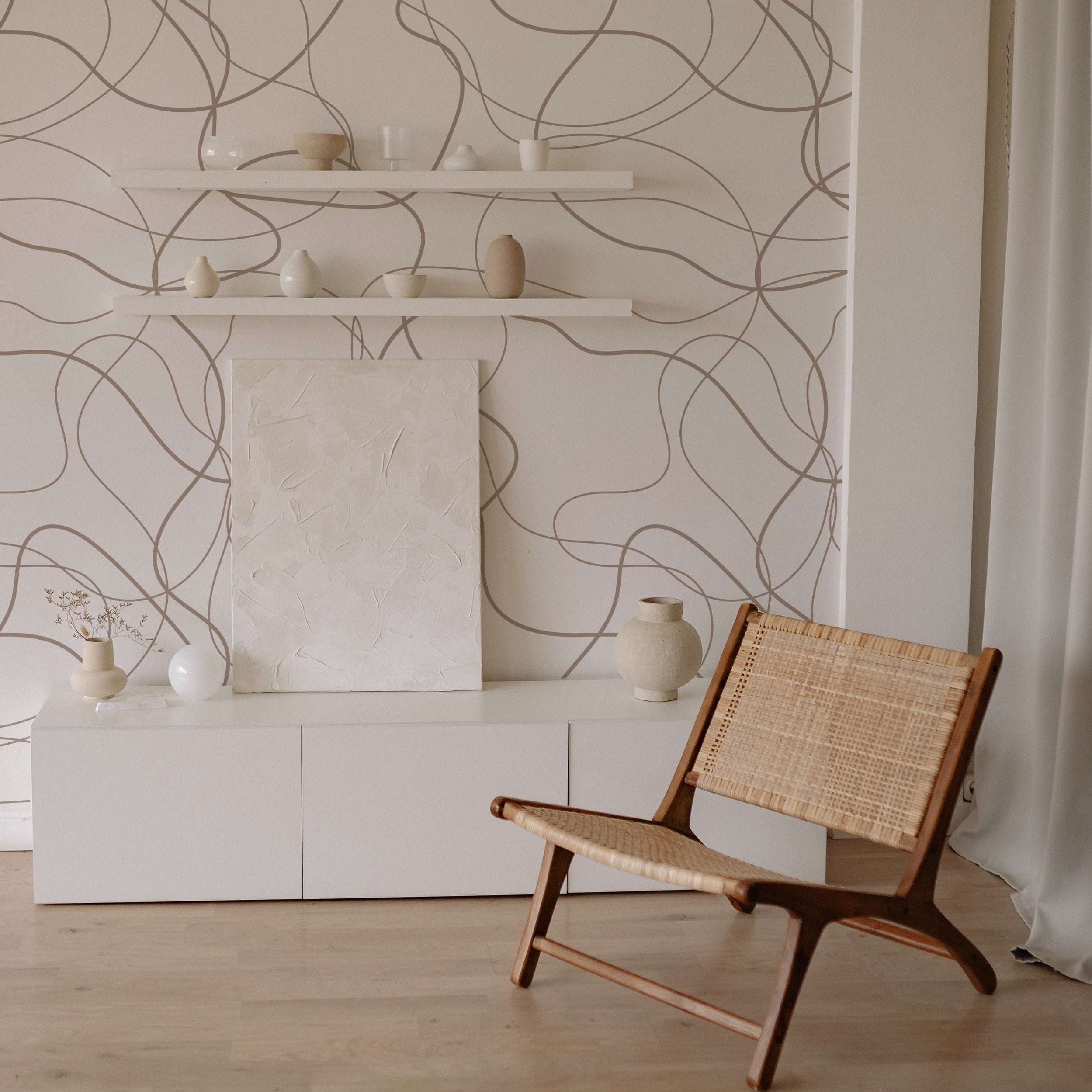 A modern minimalist living area with 'Organic Doodle Wallpaper III' adorning the wall, its free-form doodle lines creating a relaxed and creative atmosphere, complemented by simple decor