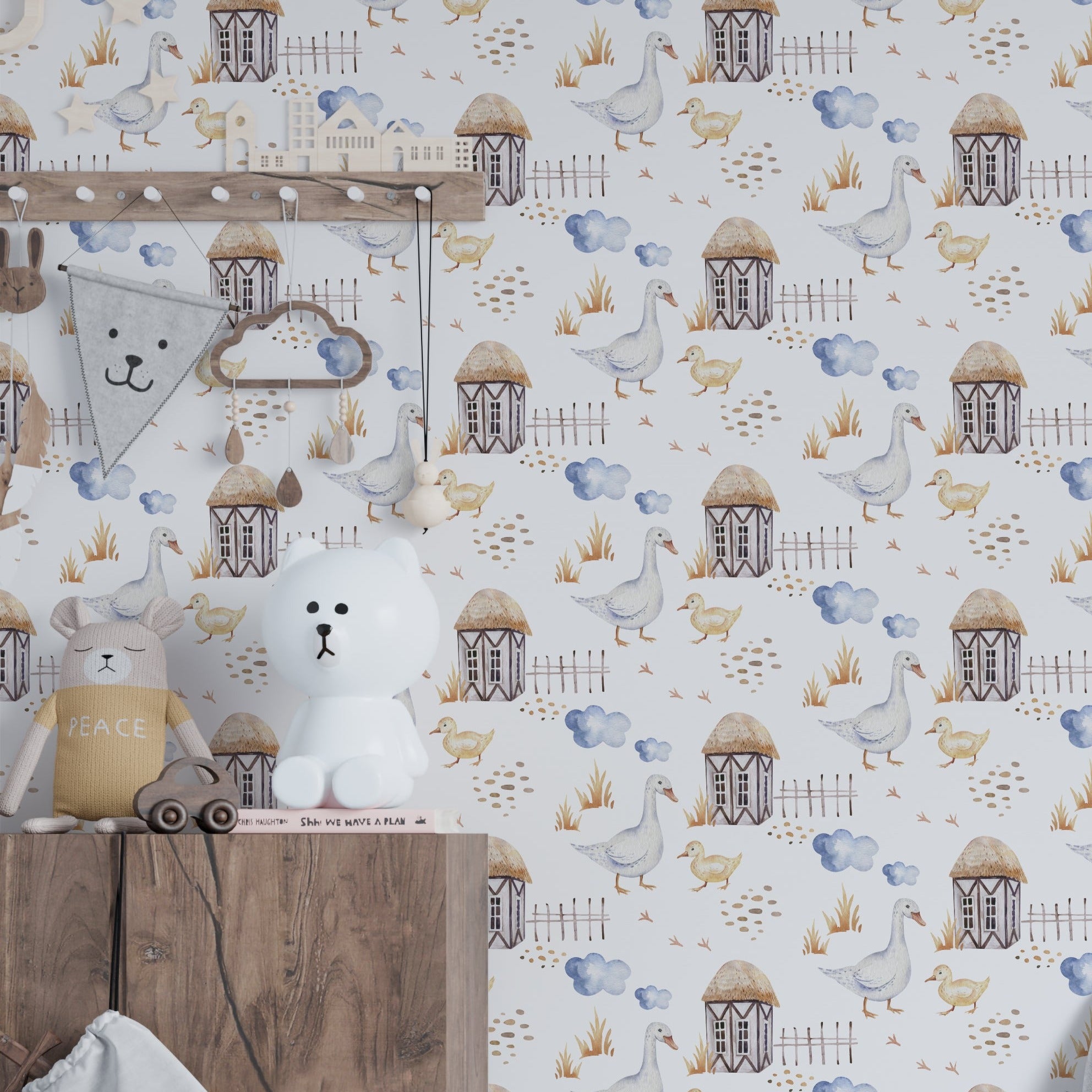 A child's nursery room decorated with 'Watercolor Farm Animals VI' wallpaper displaying a peaceful farm setting with geese and chicks near quaint farmhouses, enhancing the room's cozy and pastoral ambiance