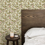 A stylish bedroom with a wooden headboard and a minimalist side table, set against a wall adorned with Vintage Garden Wallpaper. The wallpaper's nature-inspired pattern enhances the room's aesthetic, adding a touch of elegance and tranquility.