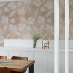 Elegant interior featuring Shimmer and Floral Wallpaper with a soft beige background adorned with white floral patterns and subtle golden shimmer accents. This wallpaper enhances the dining area, adding a luxurious yet understated charm