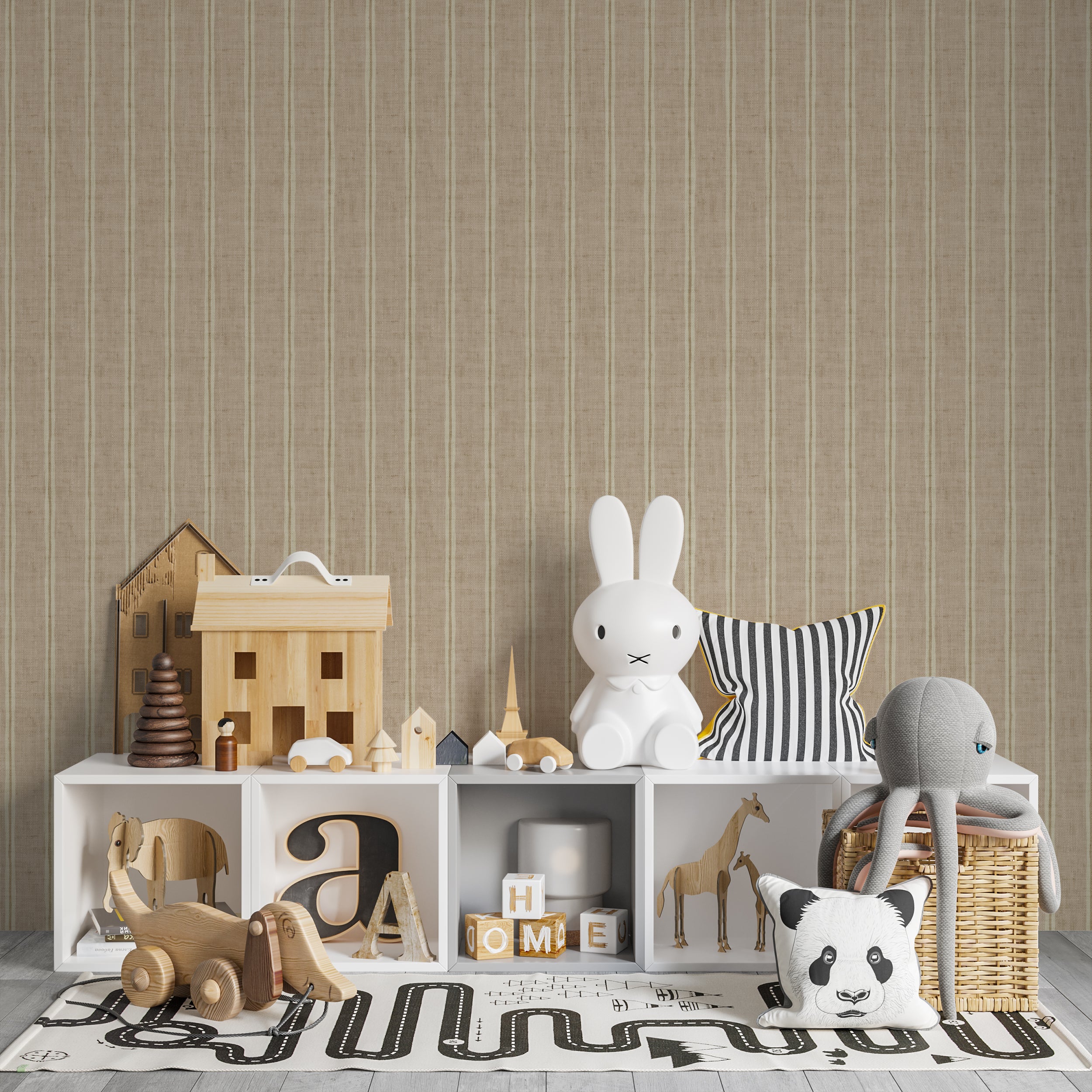 A children's play area featuring the 'Ticking Fabrics 2 Wallpaper' which provides a neutral backdrop with its beige and cream ticking stripes. The pattern complements the playful assortment of toys and stuffed animals arranged on the white cubby storage and adds a sophisticated yet playful atmosphere to the room.