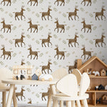 Decorative setup showcasing the Forest Stag Wallpaper in a children’s playroom. The wallpaper’s pattern of stags and foliage complements a playful environment featuring wooden toys and furniture, enhancing the room’s natural and adventurous theme