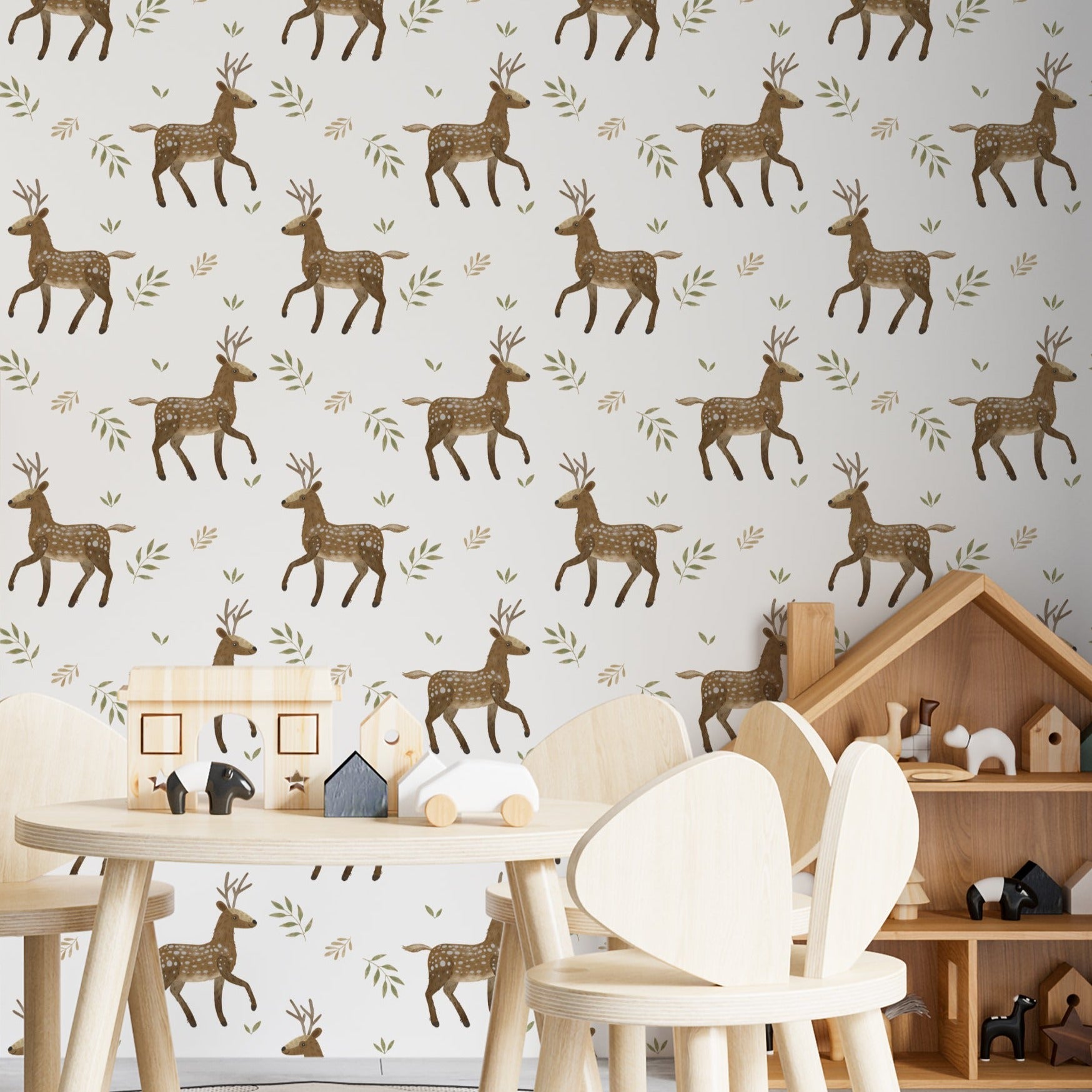 Decorative setup showcasing the Forest Stag Wallpaper in a children’s playroom. The wallpaper’s pattern of stags and foliage complements a playful environment featuring wooden toys and furniture, enhancing the room’s natural and adventurous theme
