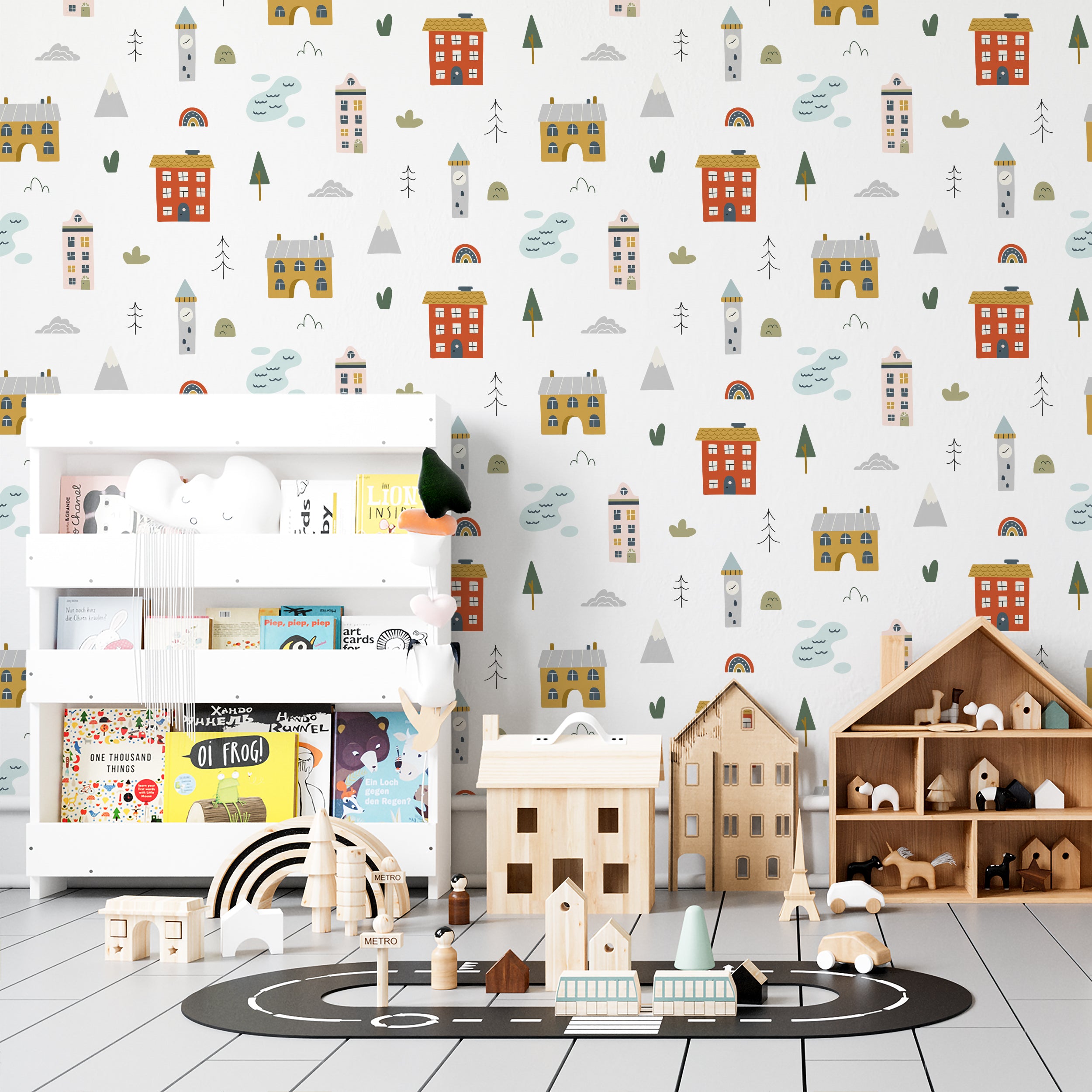 Room decor using Cute Town Wallpaper with a lively town scene including buildings and nature elements, displayed behind a children's play area with wooden toys and a house-shaped shelf, enhancing a creative and playful environment